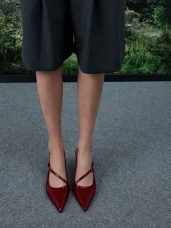 Wynn Patent Asymmetric-Strap Slingback Pumps